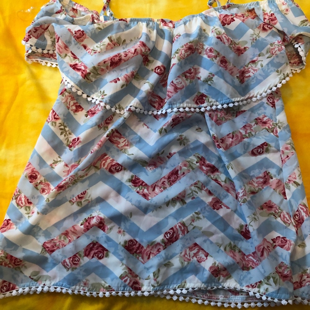 baby blue blouse with a white jagged/rose pattern